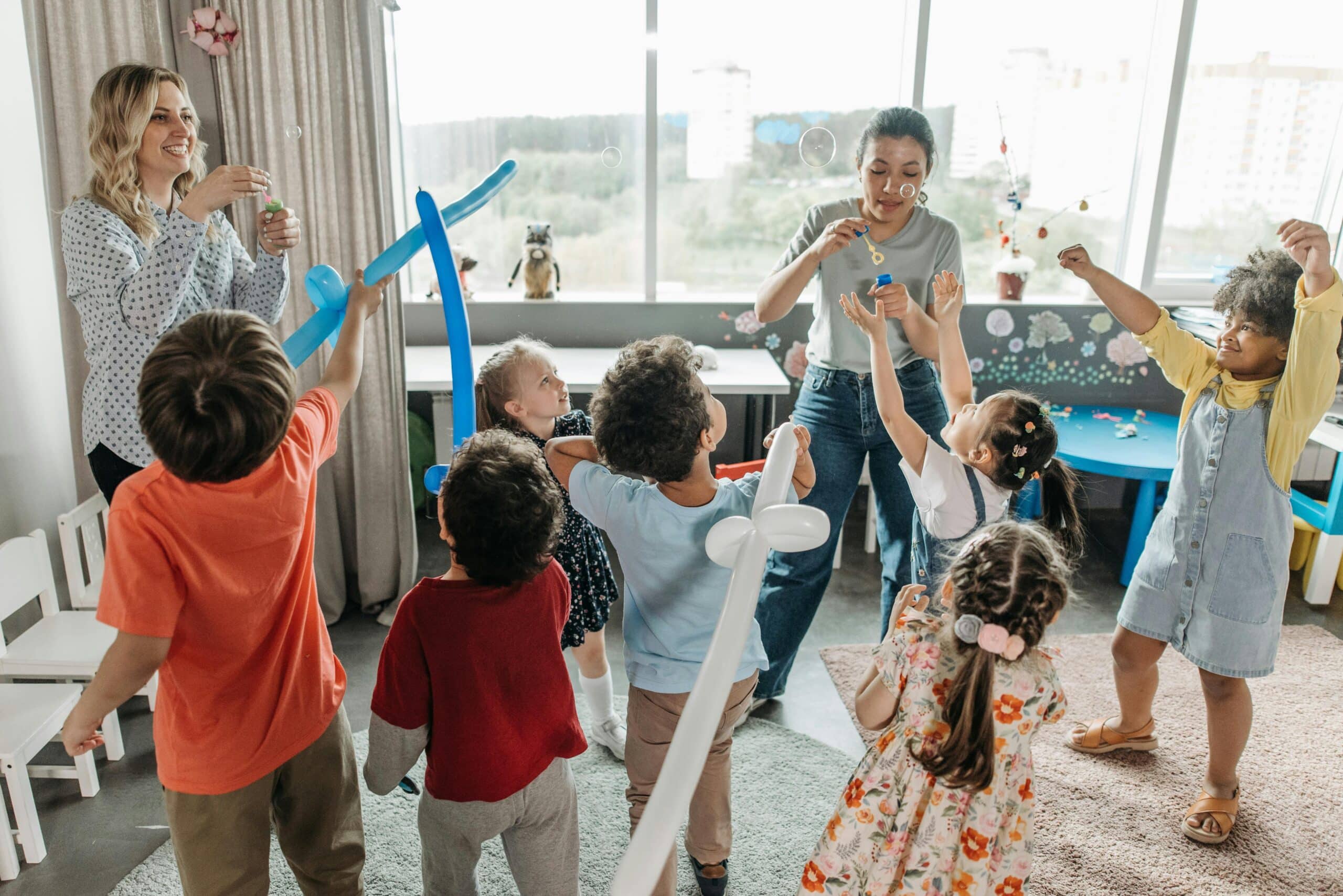 Los niños juegan con globos en una fiesta de cumpleaños infantil